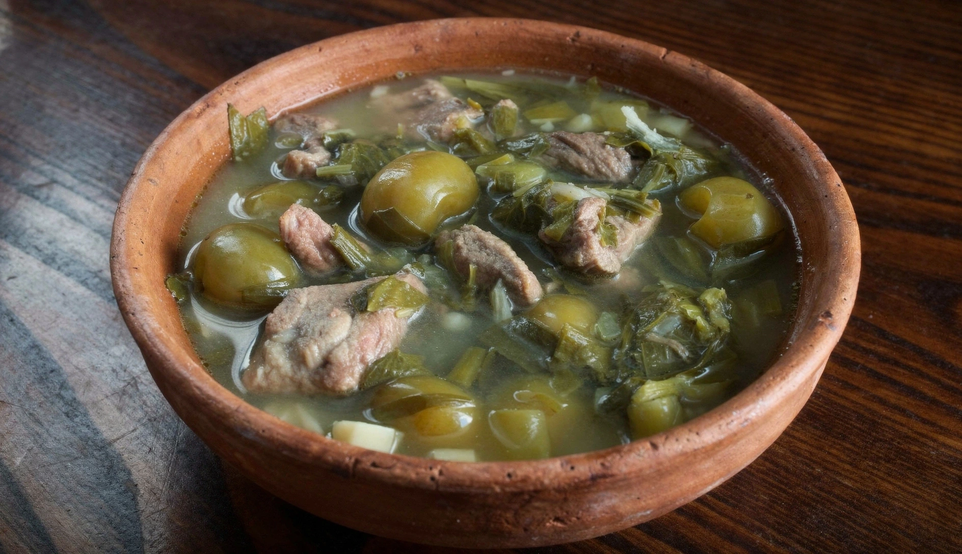 Georgian clay bowls with lamb stew garnished with fresh herbs and chili