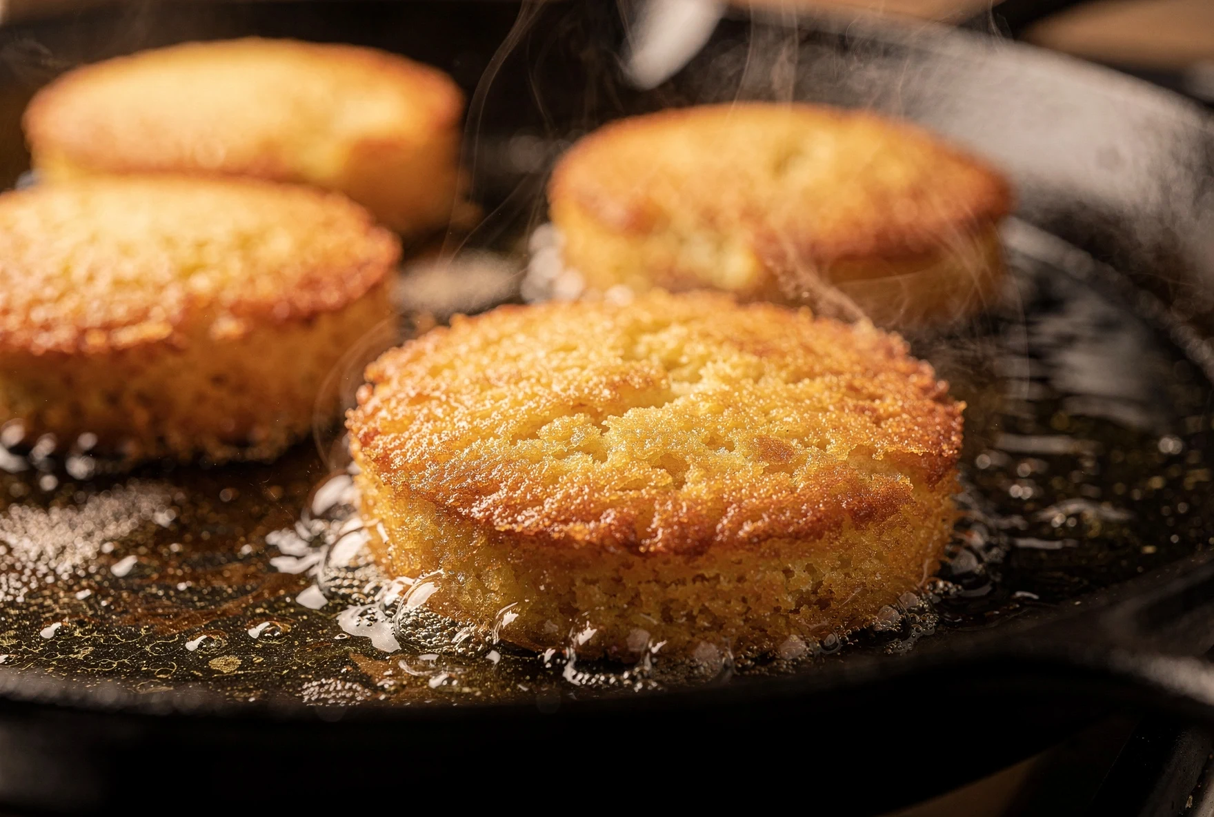 Chvishtari frying in a cast iron skillet with golden crispy crust